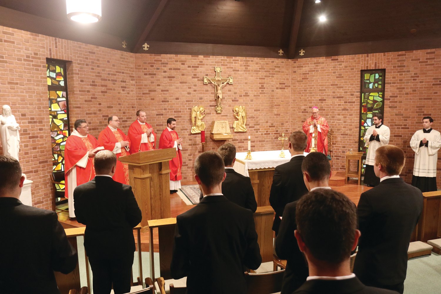 On Sept. 2, Bishop Thomas J. Tobin celebrated the opening school year Mass in the chapel of Our Lady of Providence Seminary. At top, the bishop gathers with the Providence seminarians.